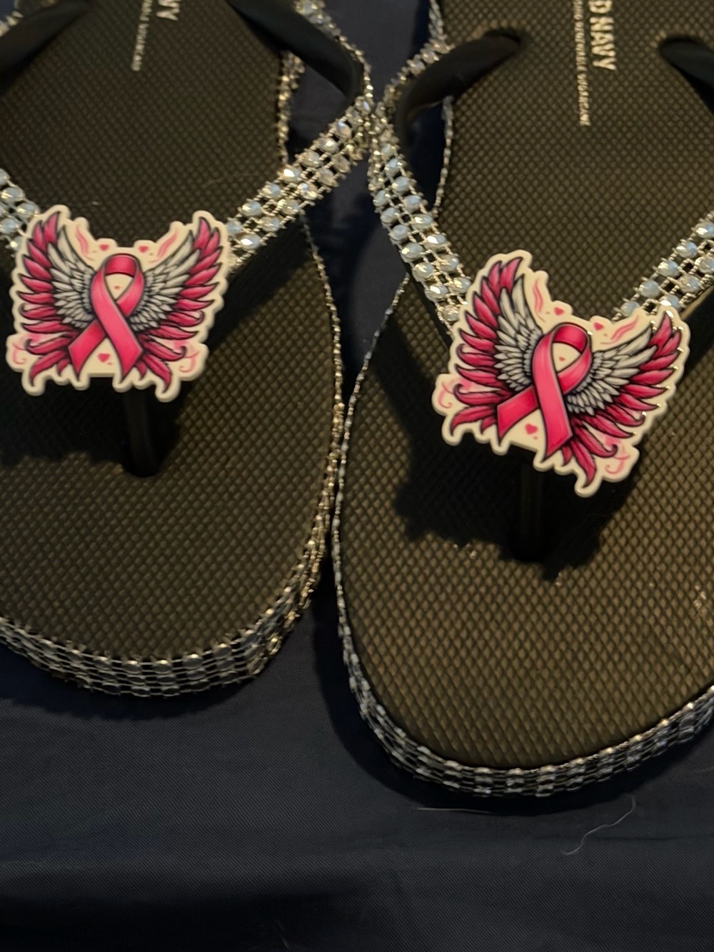 Women’s Black Flip Flops with Pink Ribbon Wing Accent